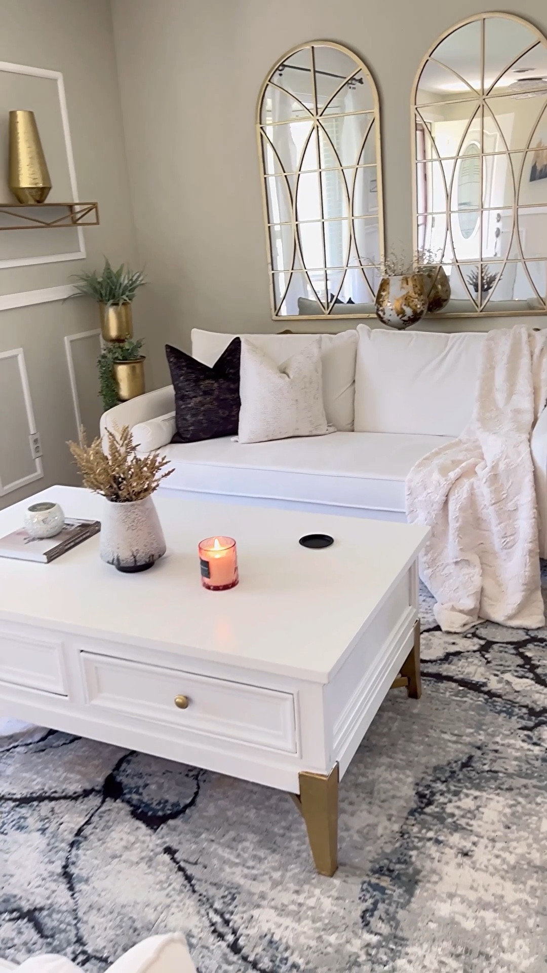 Save 65% off my abstract living room rug! Living room inspo on a budget! White sofa | white coffee table | gold arch mirror | gold home accents | neutral throw pillows | throw blanket | abstract rug 
@wayfair #wayfairhomefinds 



#LTKVideo #LTKHome #LTKSaleAlert