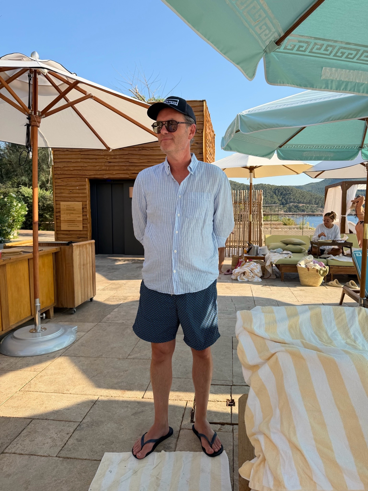 Shirt I have linked exact but it’s showing in yellow. 

The flip flops are exact.

Shorts are old McQueen, linked current similar - also linked other shorts Gregor wear on vacation. 

Sunglasses are Moscot - Björn style.

Trucker hat from Mitch’s in La Jolla