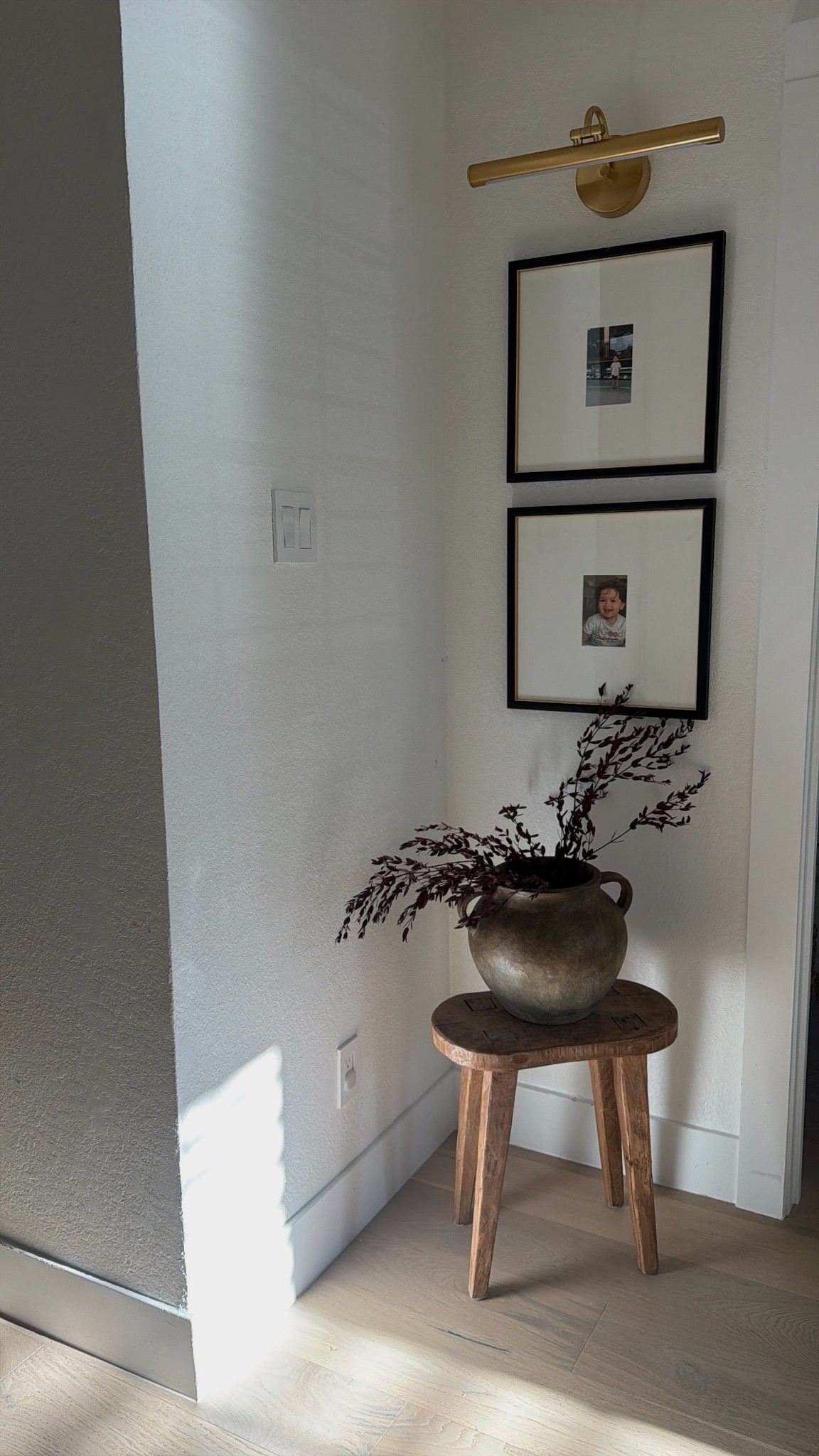 Easy corner styling with my favorite target frames and wooden stool! Light is battery operated 👏

#LTKHome