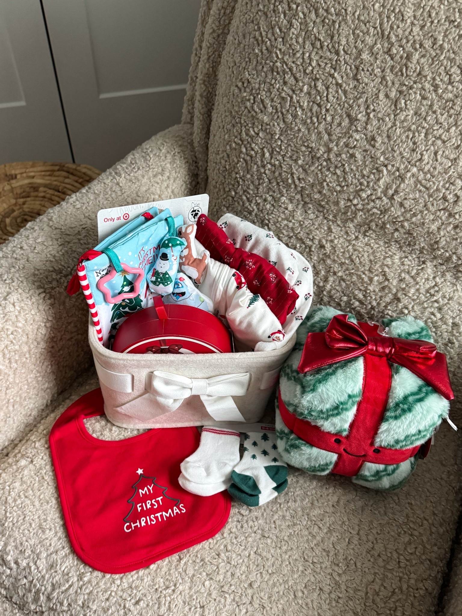 #TargetPartner Brr basket for my baby’s first Christmas🥹🎁 so many cute and affordable holiday items all from @target!! “my first Christmas” bib, festive socks, a Christmas present plush toy, handprint keepsake ornament kit, crinkle book, Christmas pjs, and holiday outfits!! #ad #TargetBabyAmbassador