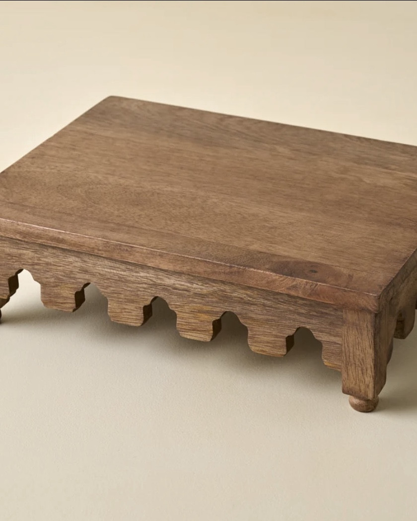 ARCHIE SCALLOPED WOODEN RISER

I collect and use risers all the time- on tables, dressers, sideboards, shelves.. to add height to centerpieces… this is a great one  with a reasonable price! 
Could even use on a bathroom vanity. Think outside the kitchen! 