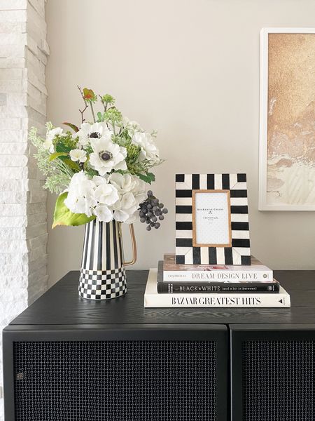 Living room decor, black and white decor, coffee table books, faux floral arrangement with vase, black console styling, Mackenzie Childs picture frame

#LTKhome #LTKSeasonal