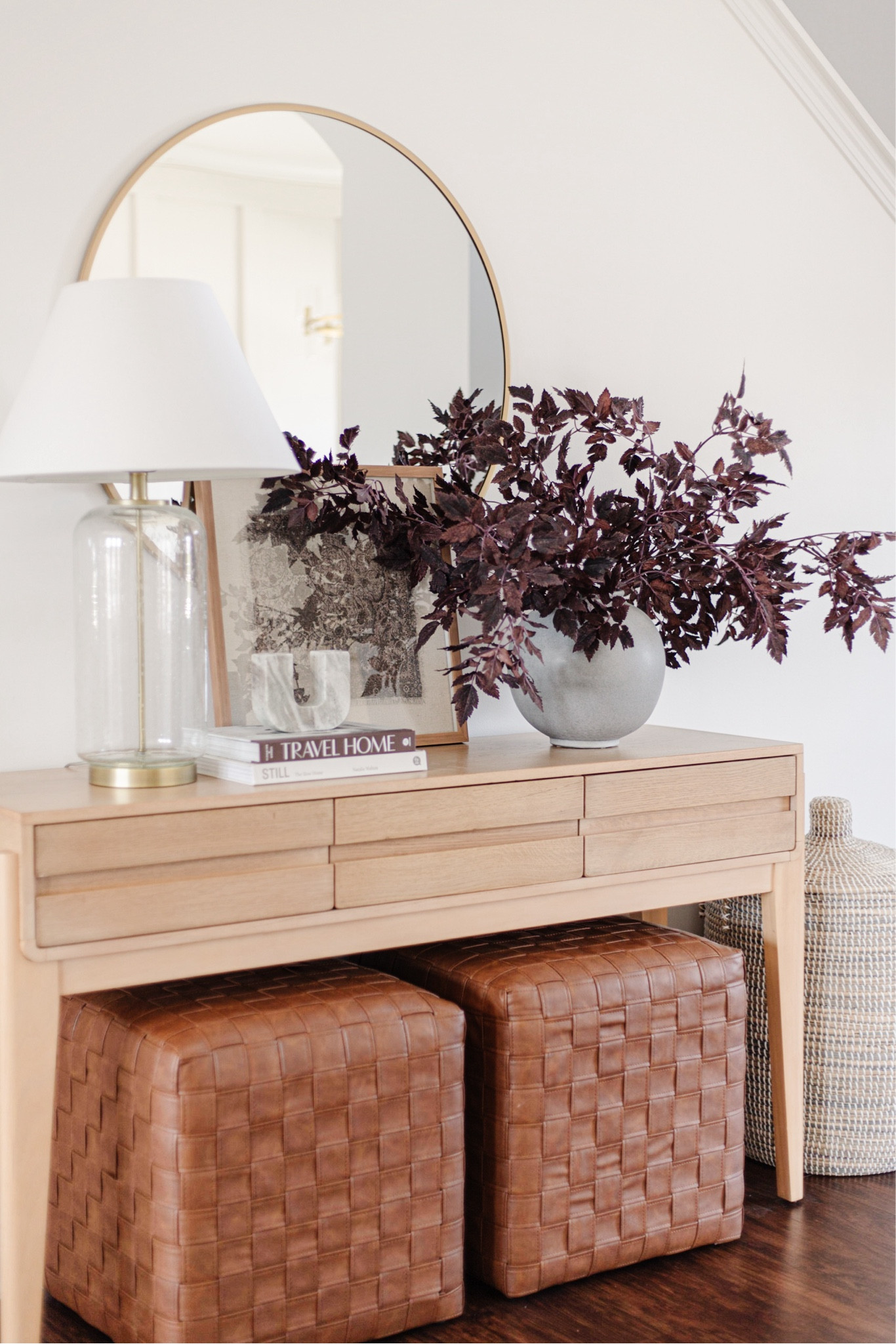 Faux autumn leaves in vase, purple foliage, faux leather woven cube ottoman, large round mirror, large glass table lamp

#LTKSeasonal #LTKHome #LTKStyleTip