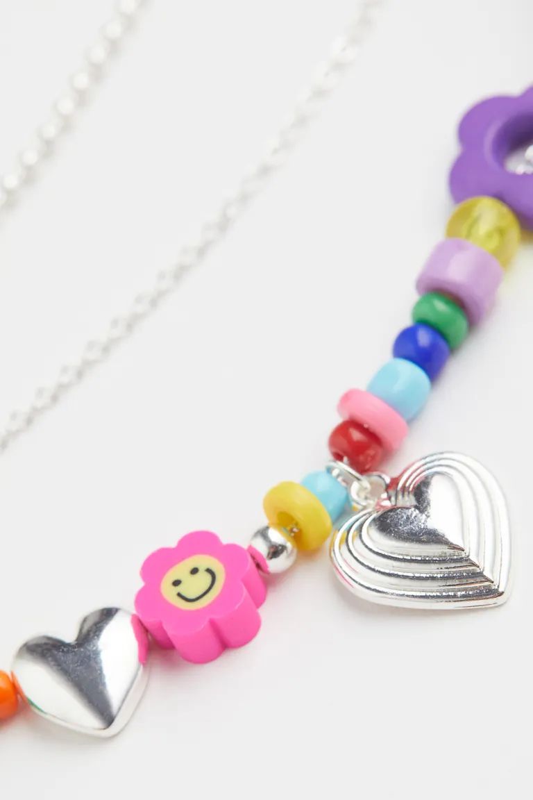 Triple-strand necklace in metal chain with different designs. Longest chain with brightly colored... | H&M (US + CA)