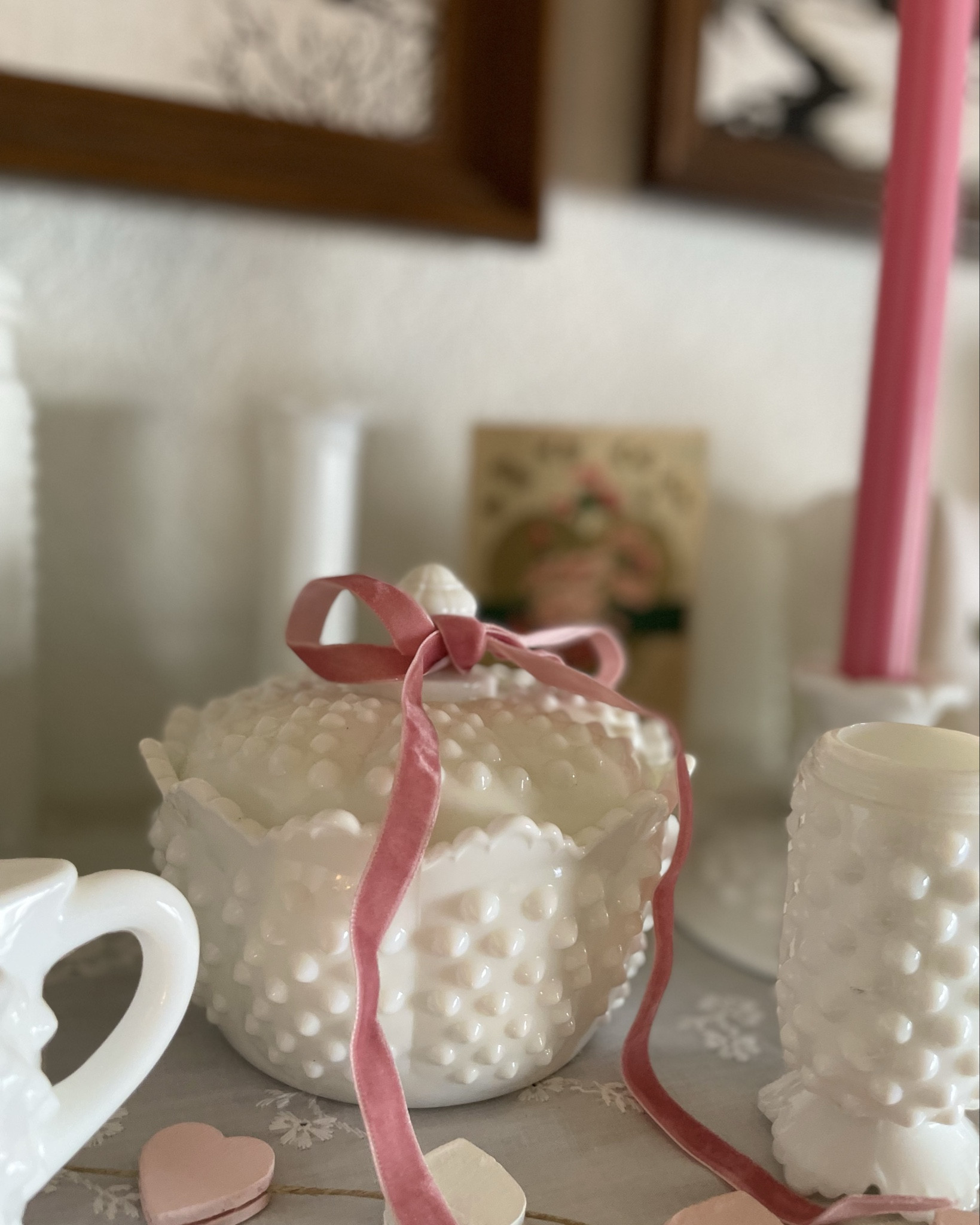 The cutest romantic and feminine Valentine’s Day decor doesn’t need to cost a thing! Pink ribbons 🎀 and a few fabric hearts gave my milk glass shelf a refresh for the occasion. 

#LTKHome #LTKValentine #LTKSeasonal