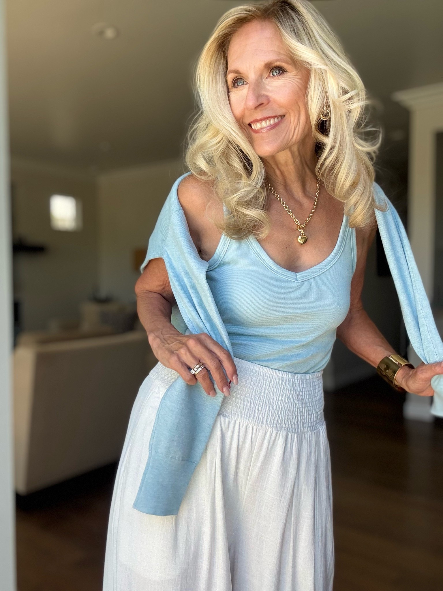 If you’re over 50, here’s proof that simple pieces can make the biggest statement.

Style doesn’t have an age limit. At 70, I’m more confident in my style choices than ever.

Today’s look is all about soft colors, and timeless basics.

These flowy Palazzo pants are incredibly comfortable, but the smocked waistband also creates a flattering silhouette.

This light blue rib tank has just enough color and there is a built-in bra with this top!

Draping this light weight V-neck sweater over my shoulders instantly elevates this outfit and is great for chilly evenings.

My gold heart necklace, cuff bracelet, and hoops add some personality to this look.

Jewelry @rosssimons 

Fashion after 50, and yes 70, isn’t about dressing younger. It’s about dressing in a way that feels authentic, confident and completely you.

Follow me for more 50+ style 
inspiration.

#LTKOver40 #LTKootd