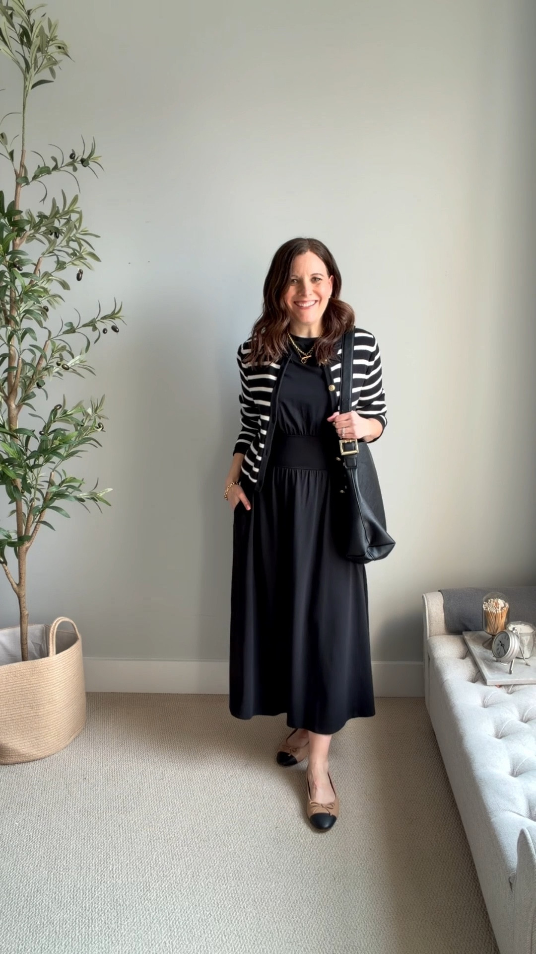 This black-and-white cardigan is a wardrobe staple that adds so much visual interest when layered over a simple black dress. Tan and black cap-toe ballet flats are classic and make this outfit feel put together. I’m carrying a relaxed, oversized black bag for an unexpected pairing that feels laid-back. Fit note: dress fits tts. I’m in a small. 

#LTKMidsize #LTKSaleAlert #LTKOver40