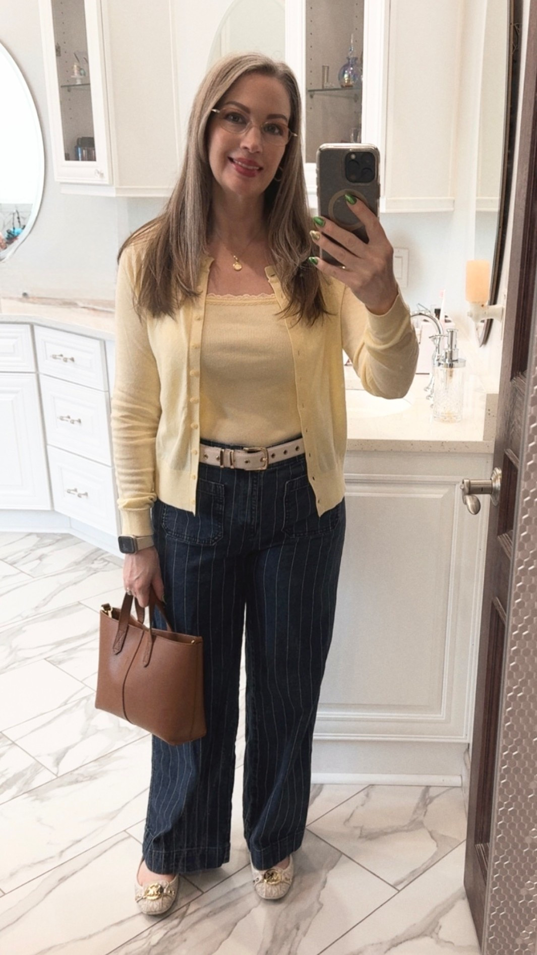 ￼ Sunday shopping is so much fun! Matching tank tops and cardigans are back in style, and I love this beautiful buttery yellow color — perfect for spring and summer. I'm wearing a small in the tank top and cardigan. I probably could have gone with a medium in the tank but the medium was a tad to big in the arms. I paired it with my wide-leg, pinstriped pants from LOFT, a tan bag, and my favorite Michael Kors flats. The belt was a lucky find, and it matches my flats perfectly, adding a little extra charm to the look. I purchased the belt in a medium to fit my mid and low rise pants. 

HOC Springs, the tank and cardigan are perfect matchs to banana 💛

#LTKootd #LTKSaleAlert #LTKOver40