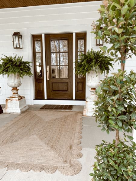We love the neutral tone and texture this scalloped jute area rug adds to our front porch! It’s one of the few pieces we kept in place during our full porch refresh for Summer. #home #rug #porch 

#LTKhome #LTKSeasonal