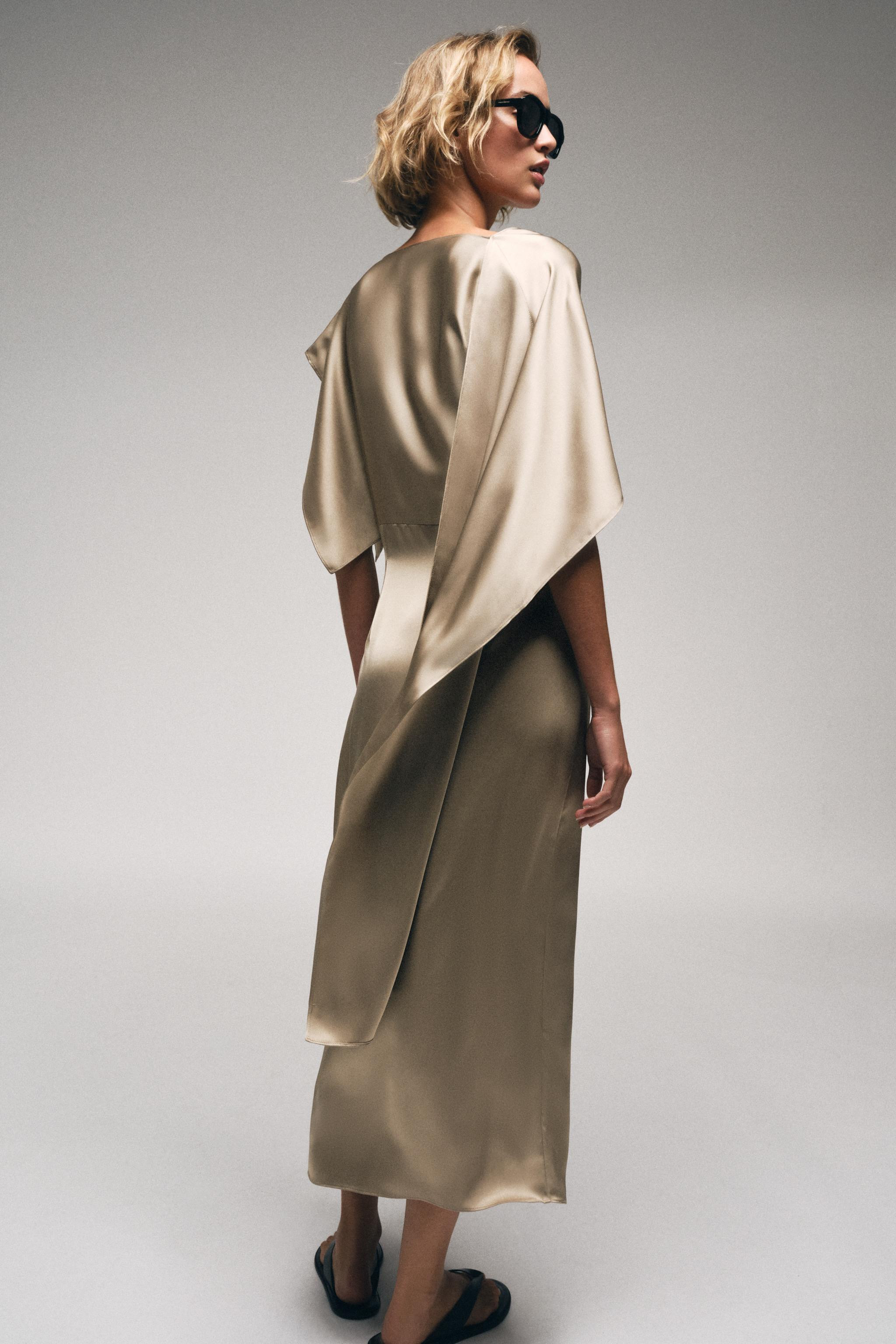 Model height: 173 cmBoat-neck dress with an asymmetric cape-style sleeve. Featuring side pleat de... | Zara UK