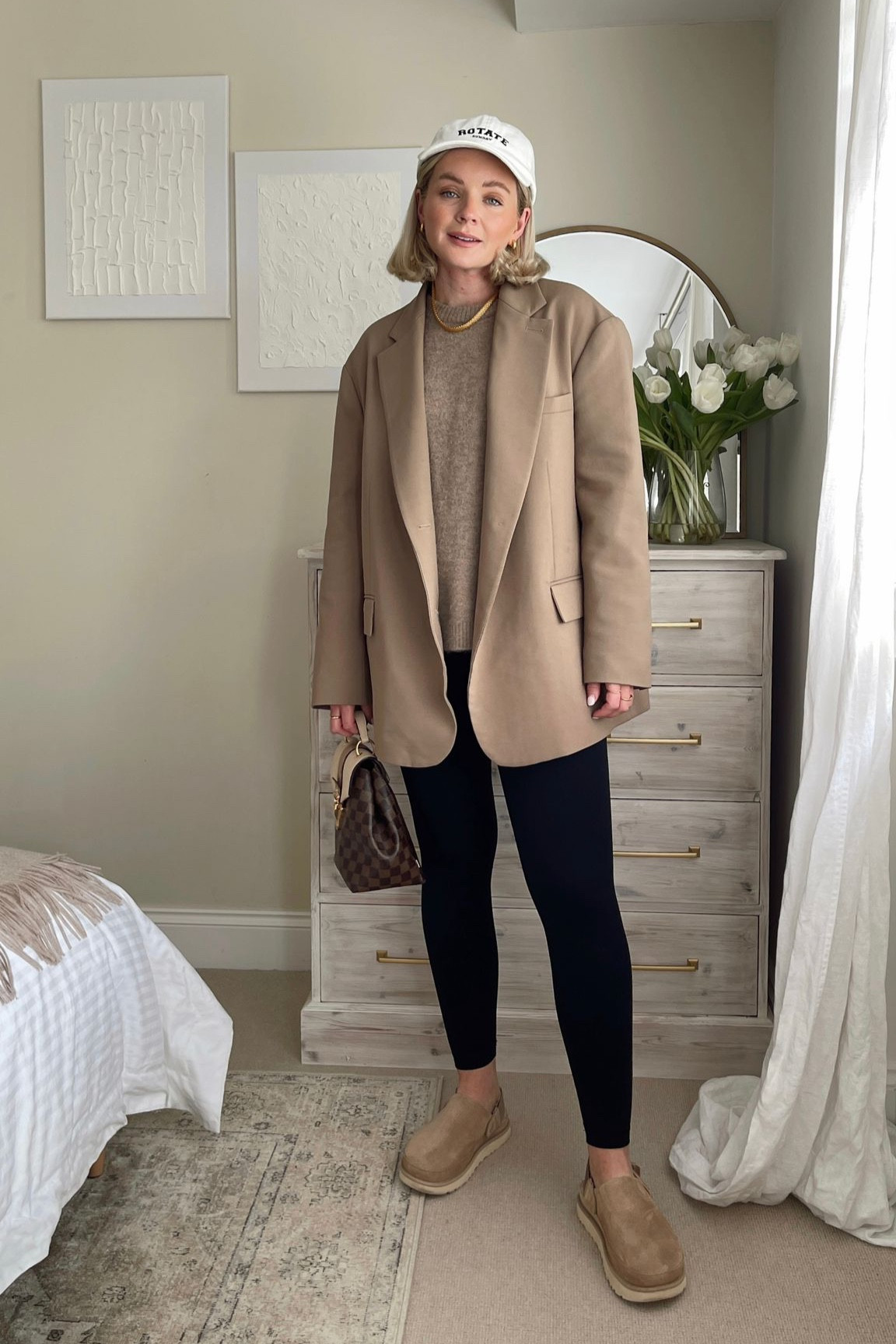 Spring outfit with high low dressing - the Frankie shop beige Bea blazer, arket cashmere beige jumper, another version black leggings, UGG goldenstar clogs, white rotate cap & monica vinader gold necklace  

#LTKSeasonal #LTKstyletip #LTKeurope