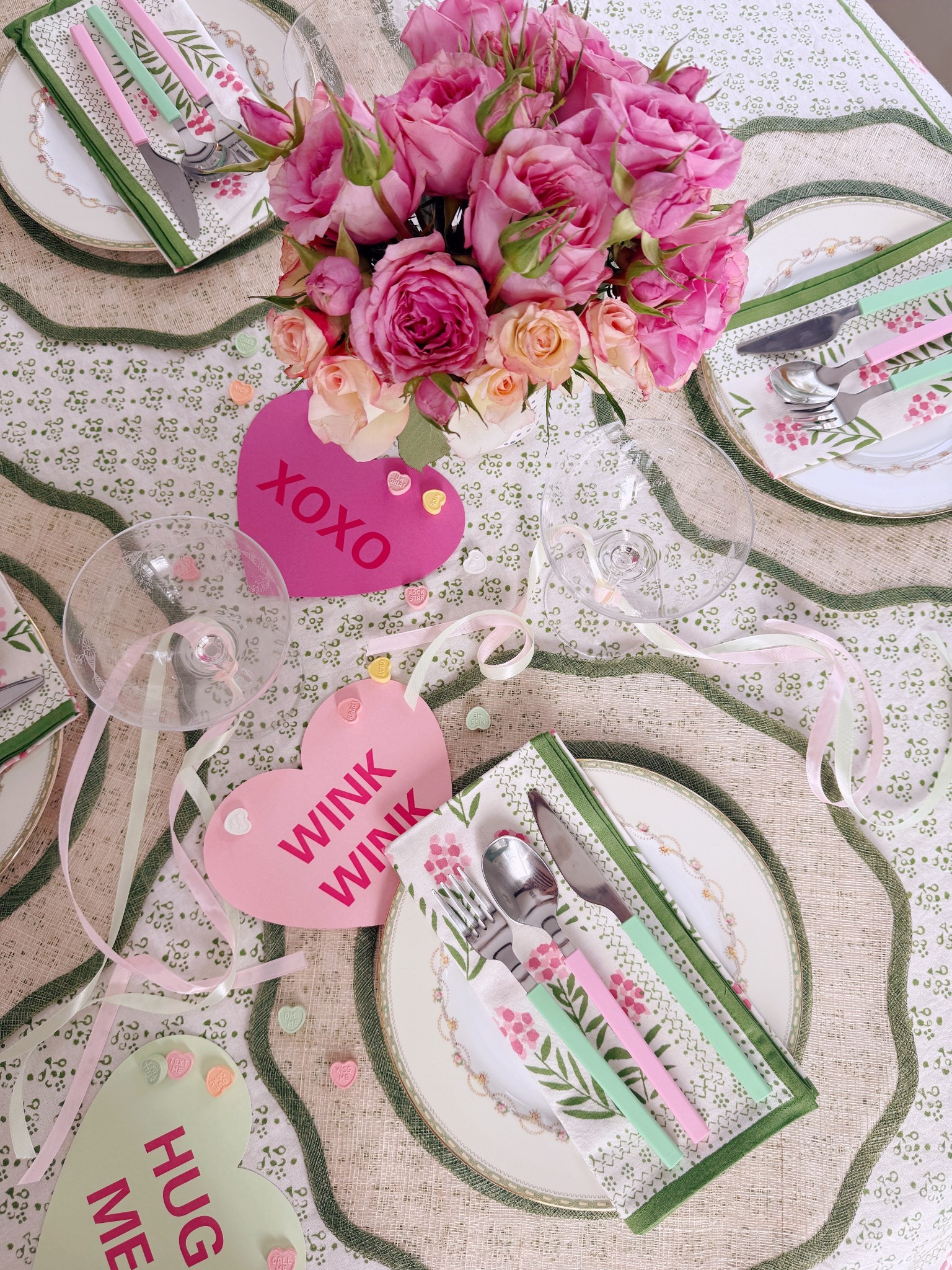 Set the table with me: Valentine's edition! Giving the traditional pink and red a softer spin for Valentine's with @pomegranate_inc's pink and green phlox print table linens! I mixed the subtle florals with a wove green placement and a collection of my pink and green ikea flatware! A few conversation hearts scattered around the place settings give the table a playful look! #domestikatesetsthetable #ad 

#LTKHome #LTKValentine