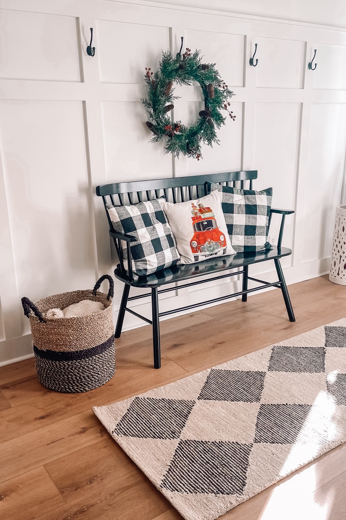 Entryway decor 
Christmas decor 
Christmas entryway 
Black farmhouse bench 
Farmhouse Christmas 
Entryway rug 
Christmas pillow 
Christmas wreath 
Wall hooks 

#LTKhome #LTKfindsunder100 #LTKHoliday