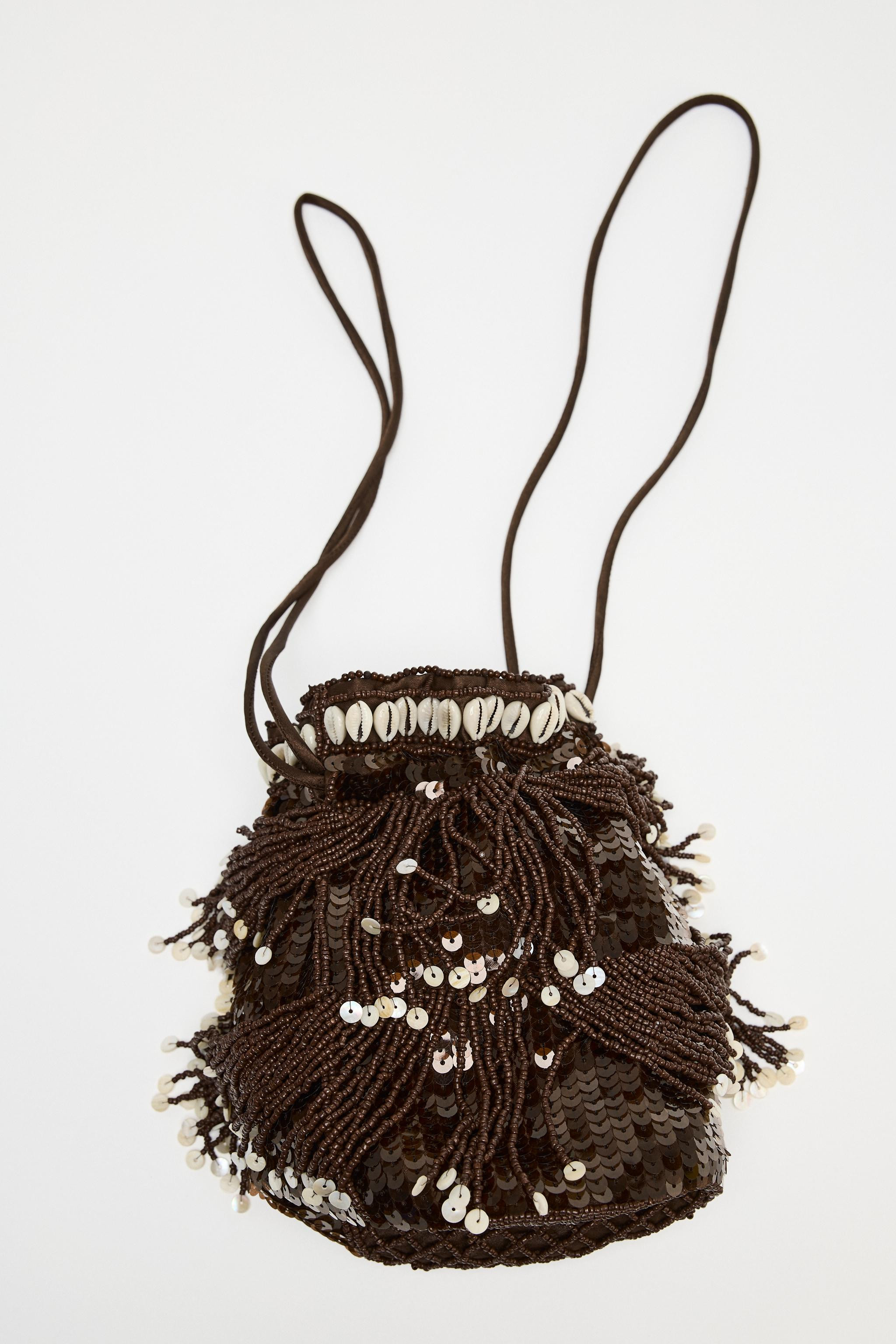 Mini bucket bag with glitter exterior, fringe, and shells. Lined interior. Double shoulder straps... | Zara US