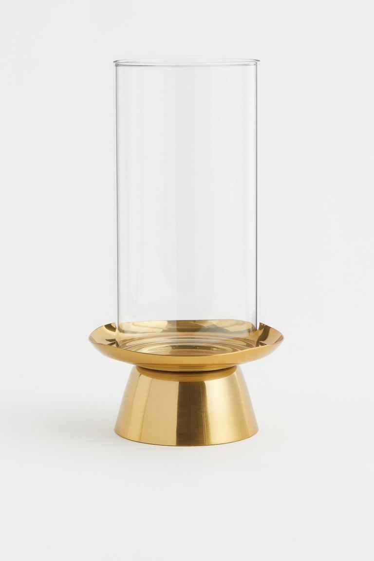 Pillar candle holder in clear glass with a slightly asymmetric base in metal. Diameter of candle ... | H&M (US + CA)