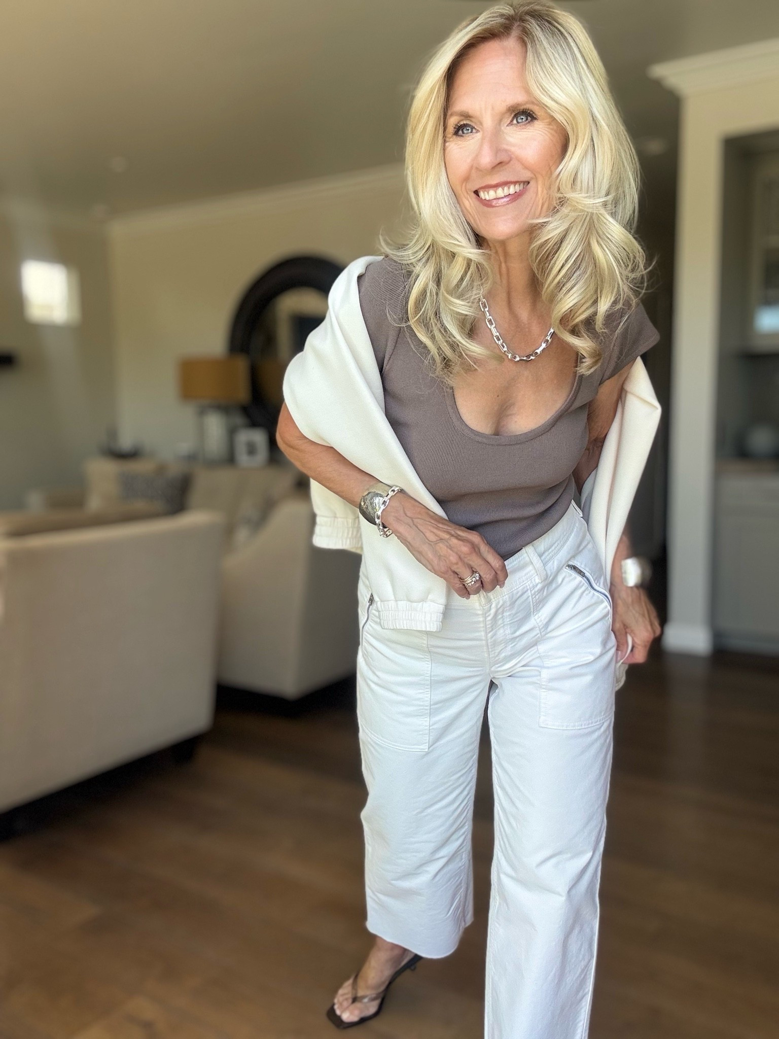 This may sound boring.

I think one of my all time favorite neutral colors is Taupe. This scoop neck sweater is such a great example.

Not only does this neutral color go with so many other colors, I love the shape of this top. It has cap sleeves, a broad scoop neckline, it’s not cropped and it really holds its shape well.

My cream wide leg cropped pants are a great length to show off my Taupe kitten heels.

I think Taupe and this top are anything but boring.

Follow me for more 50+ style inspiration.

#LTKootd #LTKOver40