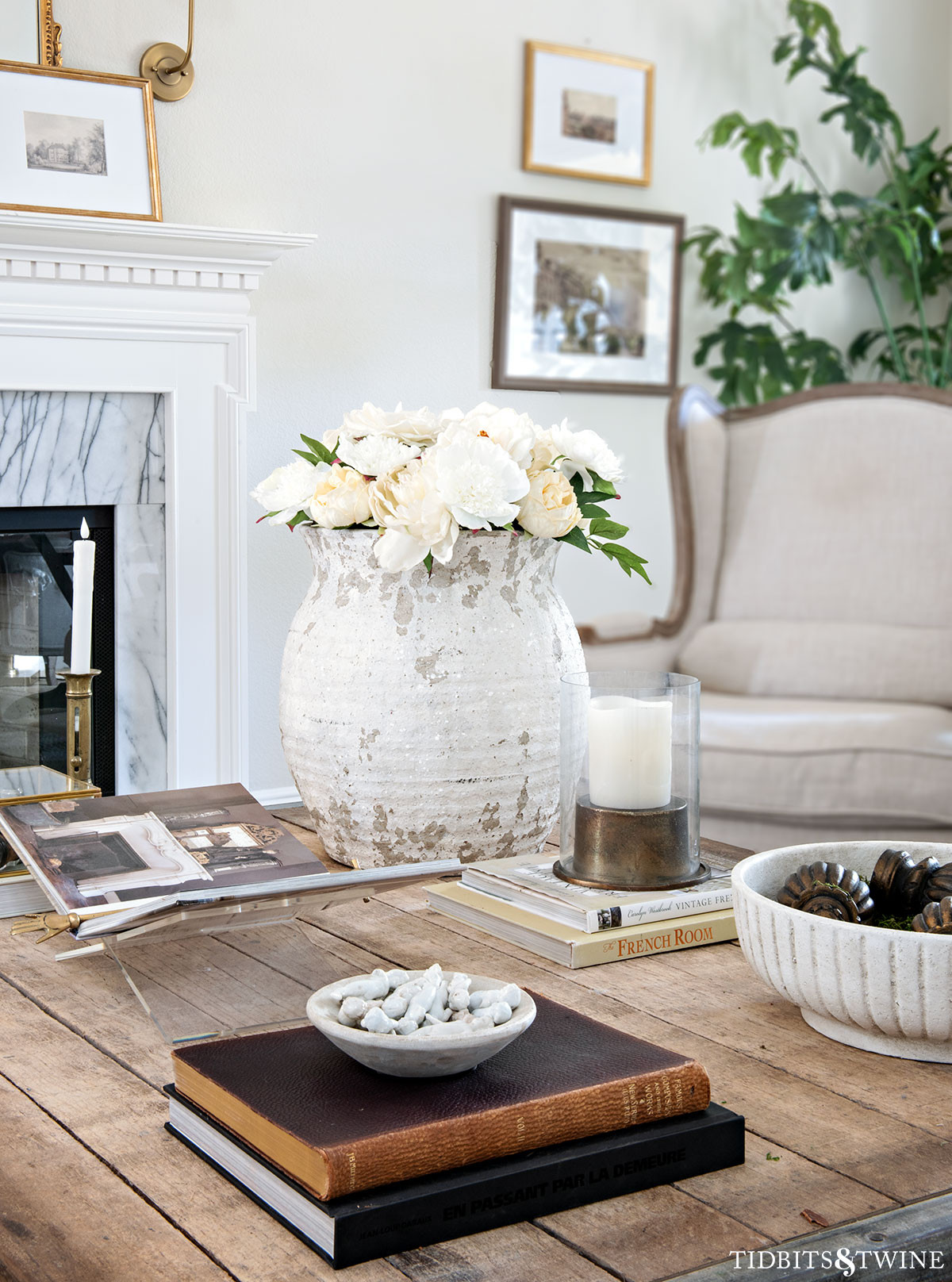 What's on my table... #coffeetabledecor #coffeetablestyling #rusticvase #fakeflowers 

 #LTKSeasonal #LTKOver40 #LTKHome