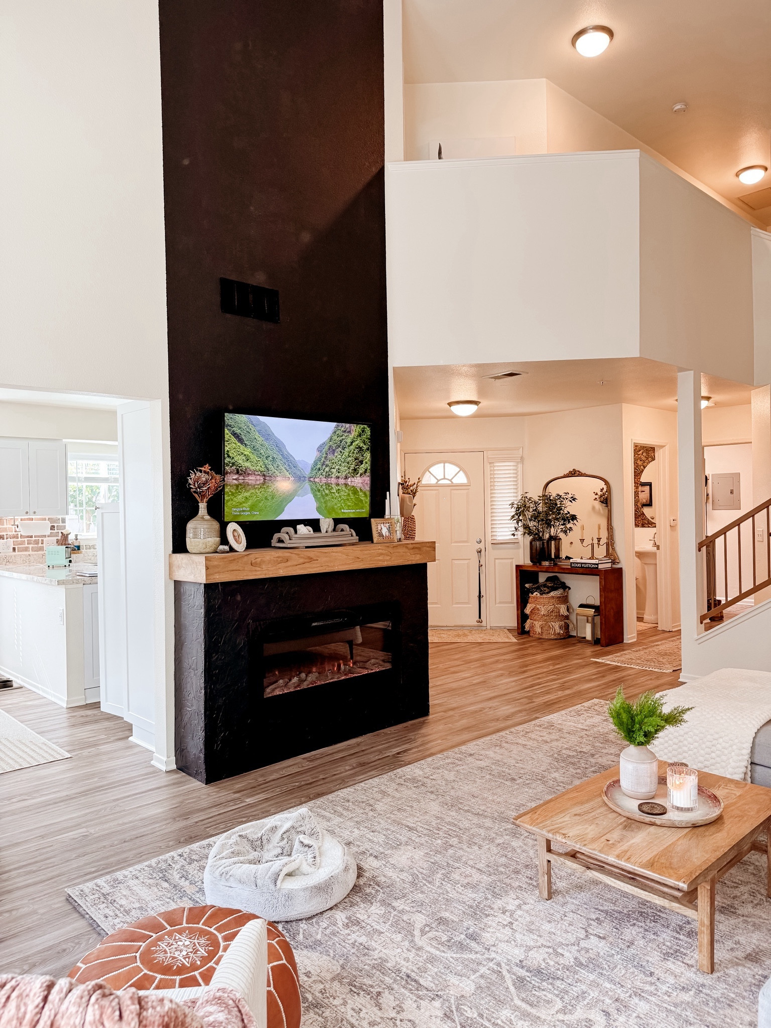 Elevated living room style! Build a fireplace surround and add your insert. Perfect for a cozy winter season. Our pup loves it too 😉

#LTKhome #LTKSeasonal #LTKstyletip