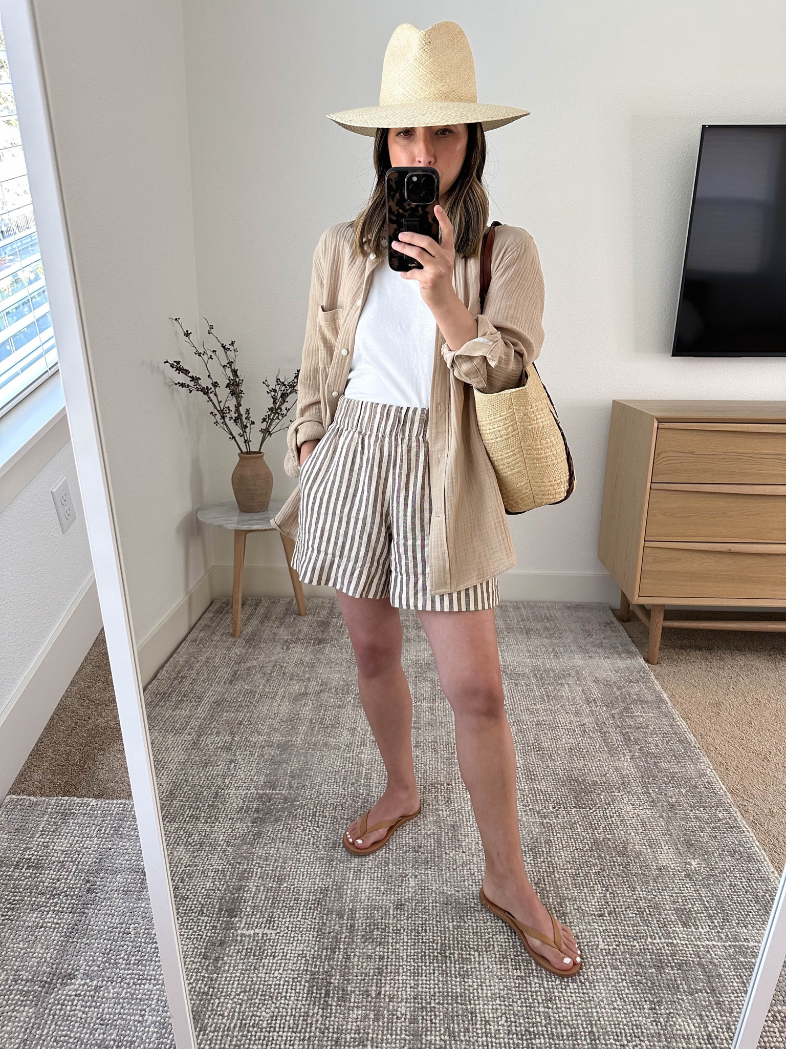 Summer outfit ideas. Easy way to style linen shorts. 

Jcrew gauze shirt 2 (old, linked similar)
Everlane tank Small. Need the xs
Gap linen shorts petite xs. This color is old. 
Beek sandals 5
Sezane tote (old)
Janessa Leone hat (old) small  

#LTKSeasonal #LTKitbag #LTKshoecrush