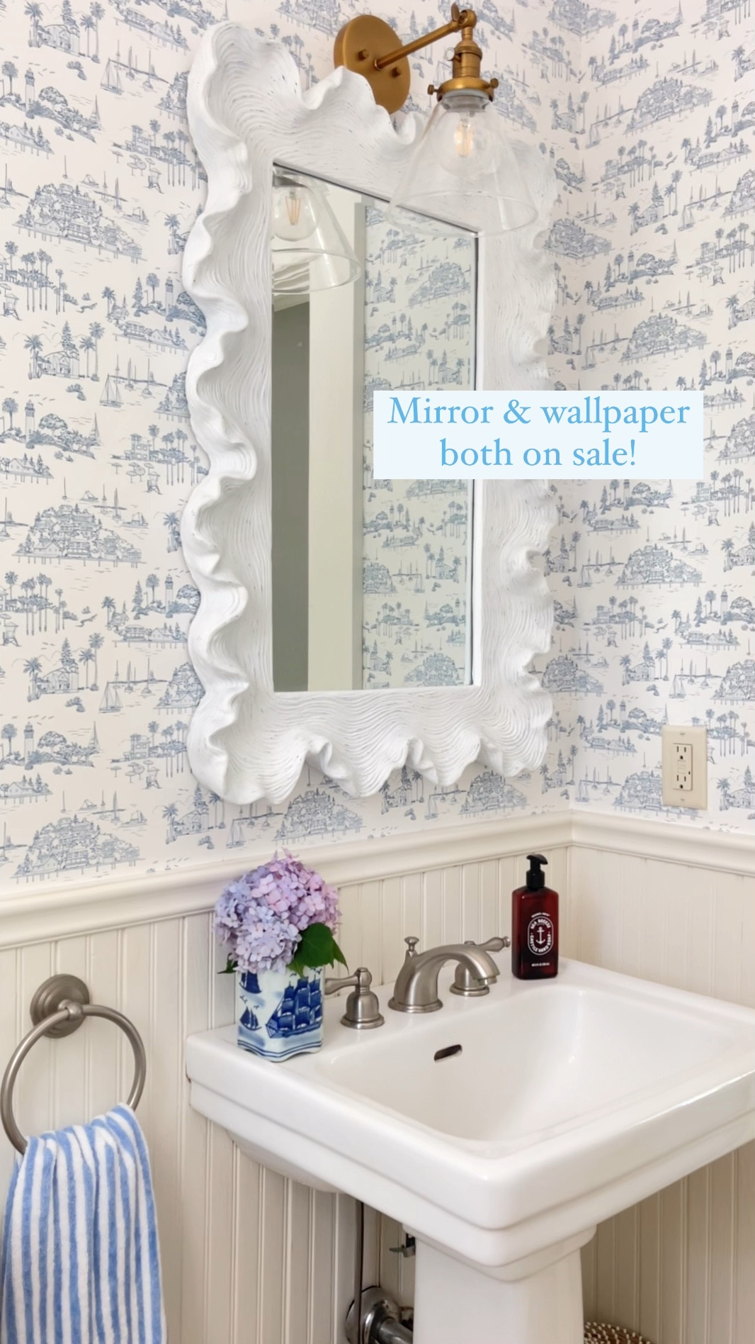 Shop our powder room white scalloped mirror and pretty coastal blue & white toile wallpaper now on sale for 4th of July!! 🙌🏻🇺🇸😍

Stripe hand towel was a recent HomeGoods find! And the blue and white vase a thrift find 🤍

#LTKHome #LTKVideo #LTKSummerSales