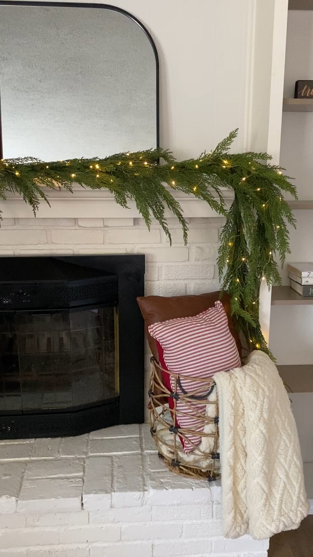 mantle decor, christmas fireplace decor, christmas throw pillows, garland, greenery, candlesticks, black mirror, arched mirror, christmas living room decor 

#LTKSeasonal #LTKHoliday #LTKhome