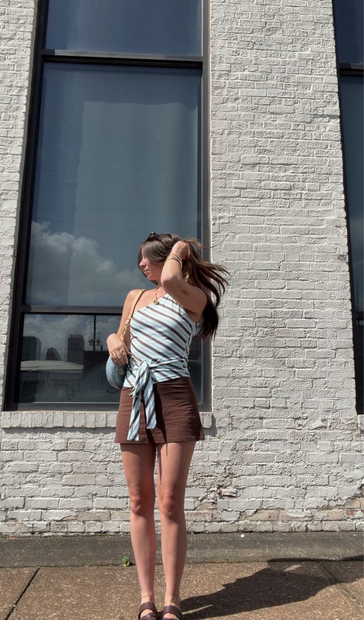 An effortless summer outfit featuring a chocolate brown mini skirt paired with a blue striped wrap tank. Perfect for everyday wear, brunch, vacation, coffee dates, and casual weekends. Neutral accessories and comfortable sandals complete this timeless, Pinterest-inspired look.

brown mini skirt
chocolate brown skirt
striped wrap top
striped tank top
blue striped top
summer outfit
casual summer outfit
everyday outfit
brunch outfit
coffee date outfit
vacation outfit

#LTKdayinmylife #LTKgrwm #LTKootd