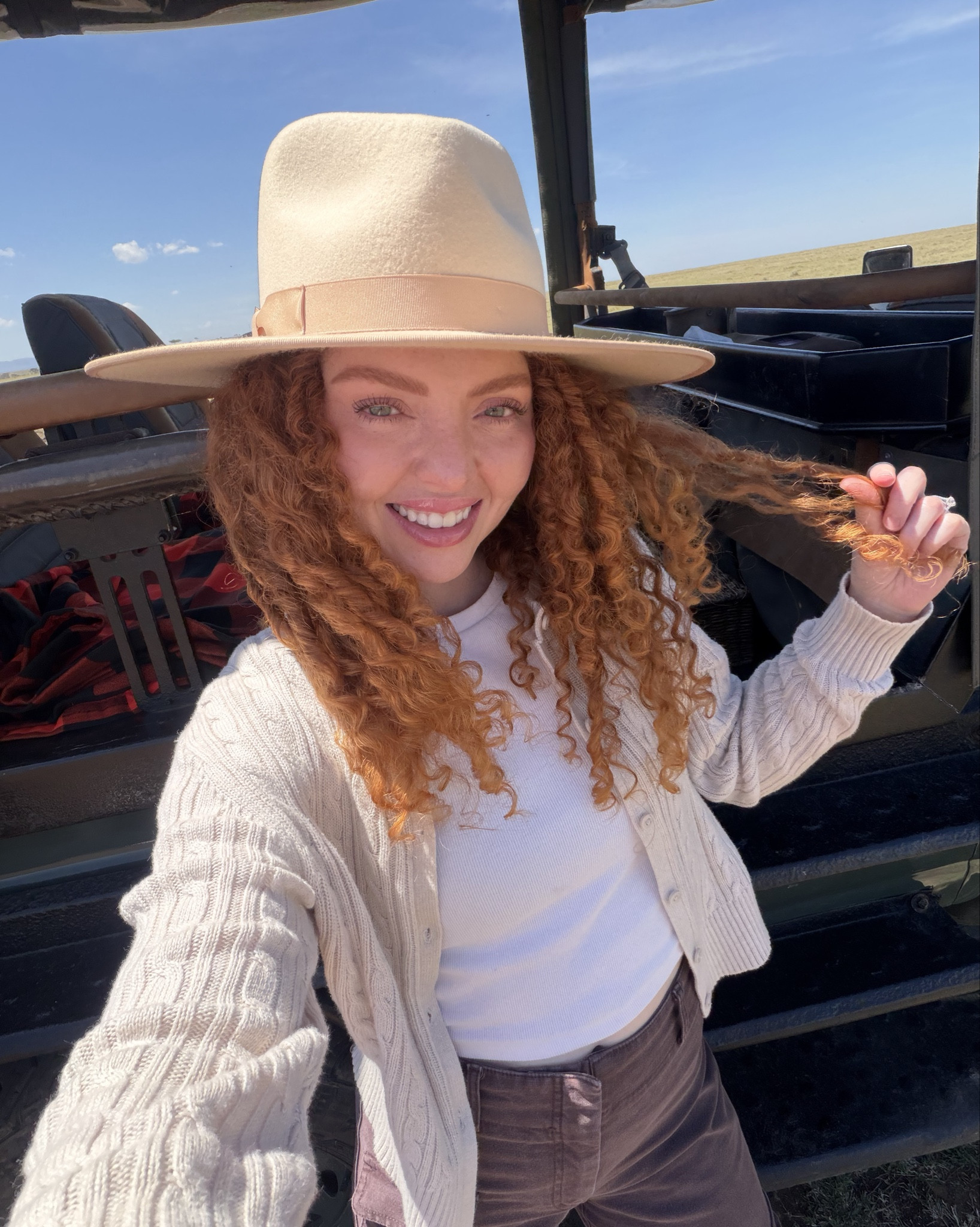 Safari outfit🤍 I packed light, but I packed a lot of things that I could make it match throughout the trip to create different outfits. Main things to consider when packing for a Safari are: 1. Comfort (you drive a LOT because of game drives.)  2. Durability (wear pants that are practical for holding things like chapstick, camera and phone.) cargo pants were my bff 3. Layers: it goes from rainy to chilly to hot. Wear layers and bring a little backpack with your rain jacket and a fleece. 4. Colors (neutral any neutral is fine, and even color but avoid red) and for shoes you want to wear closed toe, sneakers are good but I thought boots were better! I don’t recommend a light color boot, they get dusty, but I already had them and didn’t want to purchase a different color. #safarioutfit