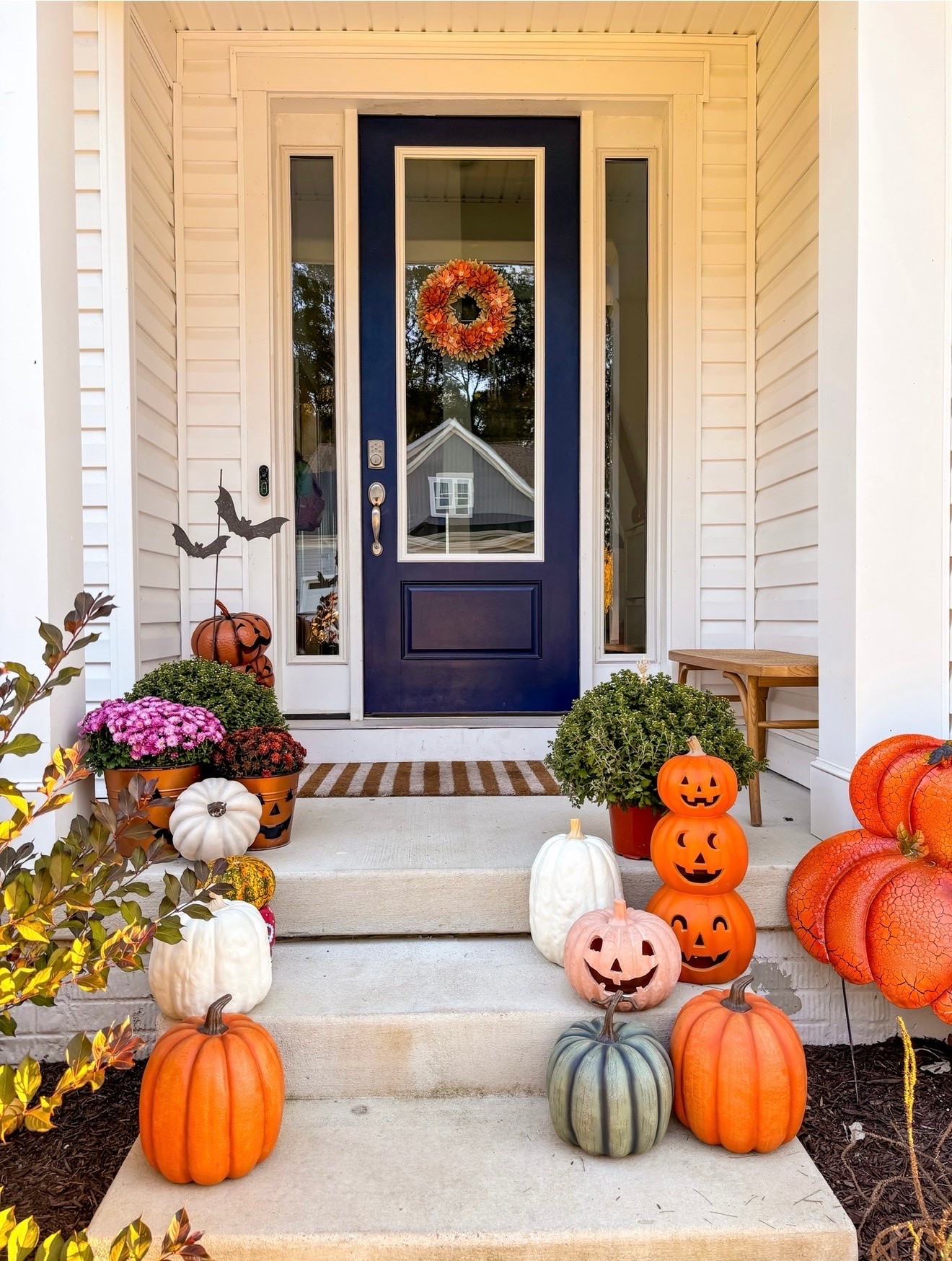 Easiest fall porch formula 🎃
→ 2–3 colors of faux pumpkins (orange, white, sage)
→ One fun pop (hello, pink jack-o'-lantern 💗)
→ Mums in any color
→ Stack 'em at different heights