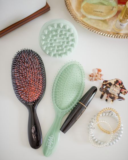 I have quite a few hair accessories and products that I rely on daily, here are my favorites! 

MASON PEARSON BRUSH 
The Mason Pearson brush is a splurge, for sure. I mean, $200+ for a hairbrush is a little nuts, I get it. But once I got this brush, which I use daily, I even splurged for a handbag-sized brush so I could carry it with me. The brush I use is called the 'popular' and it is a mixture of boar and nylon bristles. I find that the mixture of bristles works out really well for me. The brush head is pretty large, which is another plus since I have a lot of hair. The bed of the bristles is padded so when you brush close to your scalp, it feels so good- almost like a spa treatment! If I lost my brush, I would immediately replace it; that is how much I love this brush! 

WET BRUSH
This is what I use to brush through my hair right out of the shower. The bristles are further apart and flexible, so they won't likely break your hair.

TELETIES
These are the only hair ties that I use. They are the BEST, and I have practically tried them all. I use the skinnier ones for day-to-day hairstyles. I use the thick ones when working out because they hold my hair the best. 

HAIR CREAM WAND
I have so many flyaway hairs, and they often drive me crazy! I love this hair 'finishing cream' to tame the flyaways. This is great to toss into your handbag when you are on the go, and I also keep one in my bathroom!

SMALL CLIP + LARGE CLIP 
I use the small ones for hairstyles as they hold my hair so well and they are pretty. I use the large mostly to hold the hair on the top of my head while I curl or straighten the bottom half of my hair or to pull my hair back when I'm brushing my teeth, doing skincare, etc.

SCALP MASSAGER 
I thought this scalp massager was a little 'gimmicky' but not only does it feel good but it really does help to distribute shampoo and conditioner all of the way to the roots!

#LTKunder50 #LTKunder100 #LTKbeauty