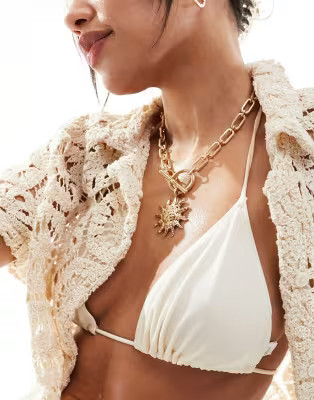 ASOS DESIGN necklace with tbar and sun charm detail in gold tone | ASOS (Global)