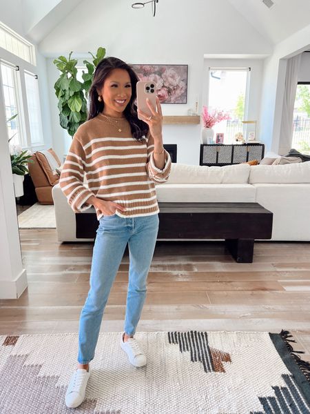 Casual spring outfit with this striped roll neck sweater on sale for less than $50! Love this for spring and summer when it’s a little chilly. 100 percent cotton and so comfortable. Pairing with Agolde straight leg jeans that are cropped and petite friendly. Love these white leather sneakers and gold Kendra Scott earrings. 