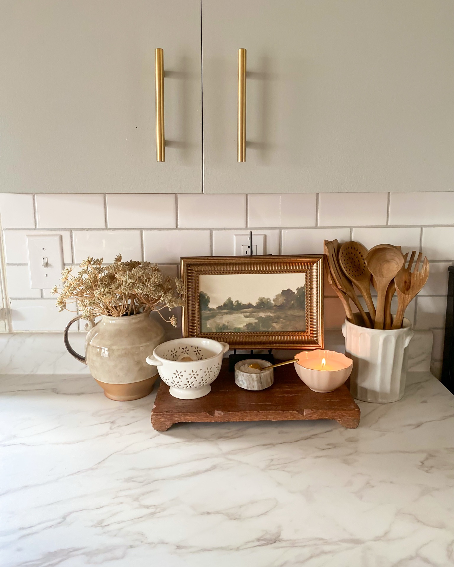 Cozy kitchen countertop styling idea 🤎 ✨kitchen inspo, utensil holder, wood utensils, easel, small art, ceramic vase, ceramic pitcher, wooden tray, salt canister, candle, gray kitchen cabinets, wood raiser, target home finds, McGee & co

#LTKMothersDay #LTKSeasonal #LTKHome