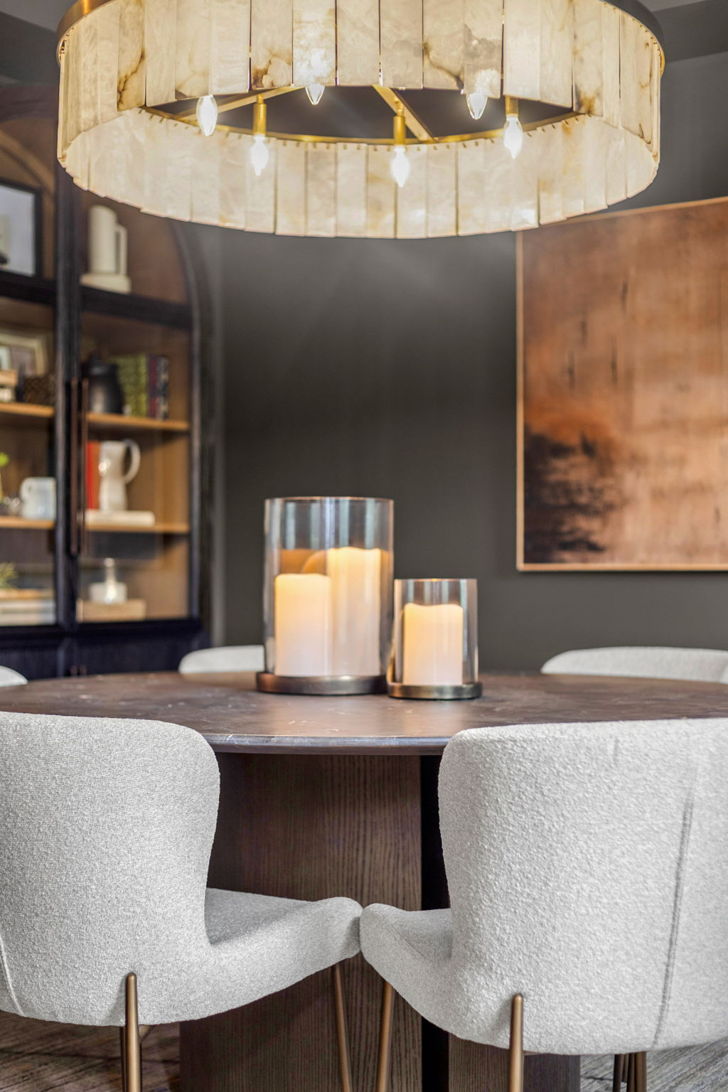 Dining Room Details: Dramatic. Elegant. Elevated 

Dining chairs we've chosen time and time again - the Kirsten from Arhaus is a 10/10 for both comfort and durability. 

The statement chandelier really shines above a complimenting round dining table, while the artwork and armoire add even more character to the space. 

Paint color: Sherwin Williams Urbane Bronze  

 #LTKHome #LTKStyleTip