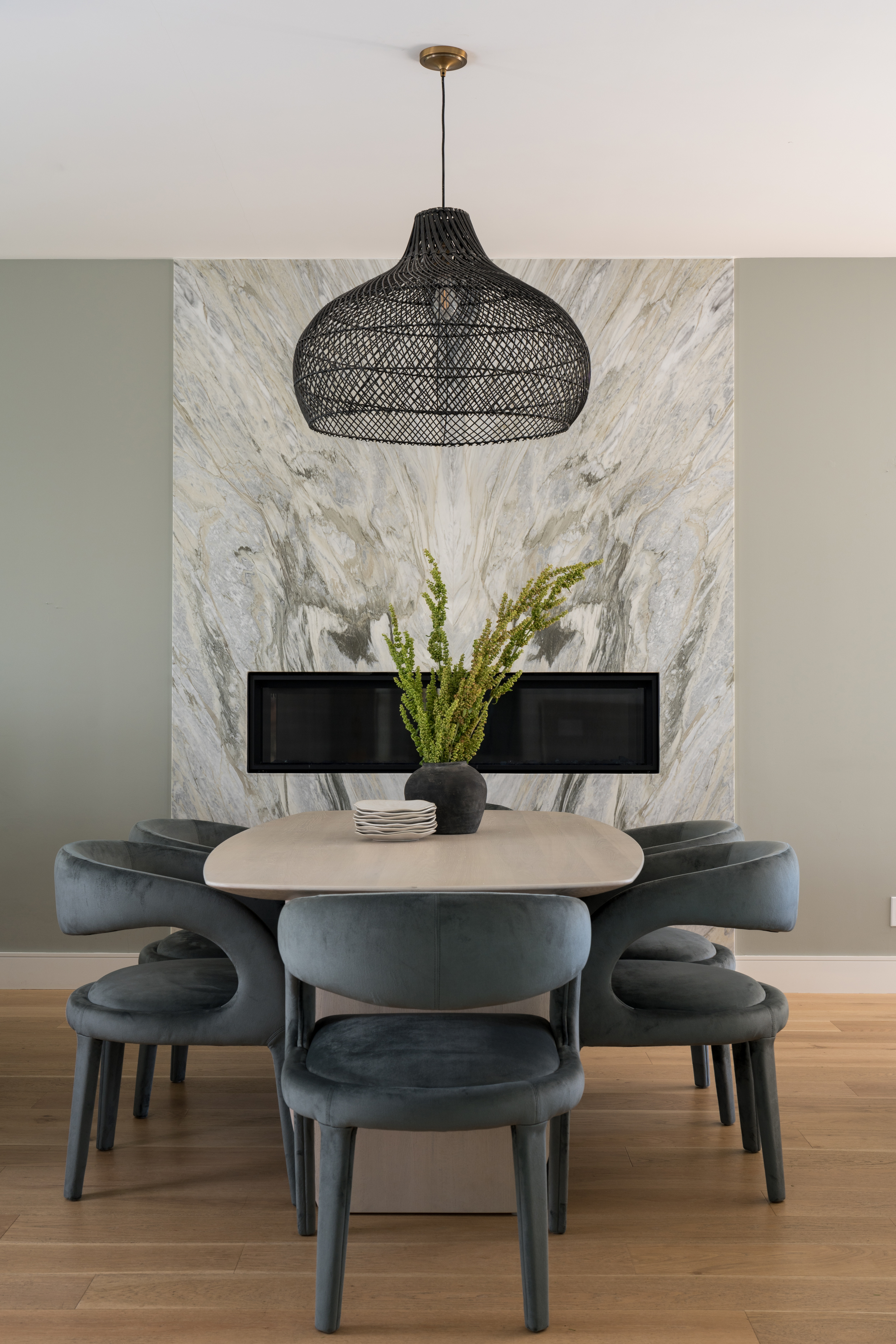 A sculptural dining space grounded by a marble fireplace, velvet chairs, woven pendant, oval dining table, and soft green walls—proof that timeless design is all about balance. 

#DiningRoomDecor #DiningRoomStyling #OrganicModern  

 #LTKHome