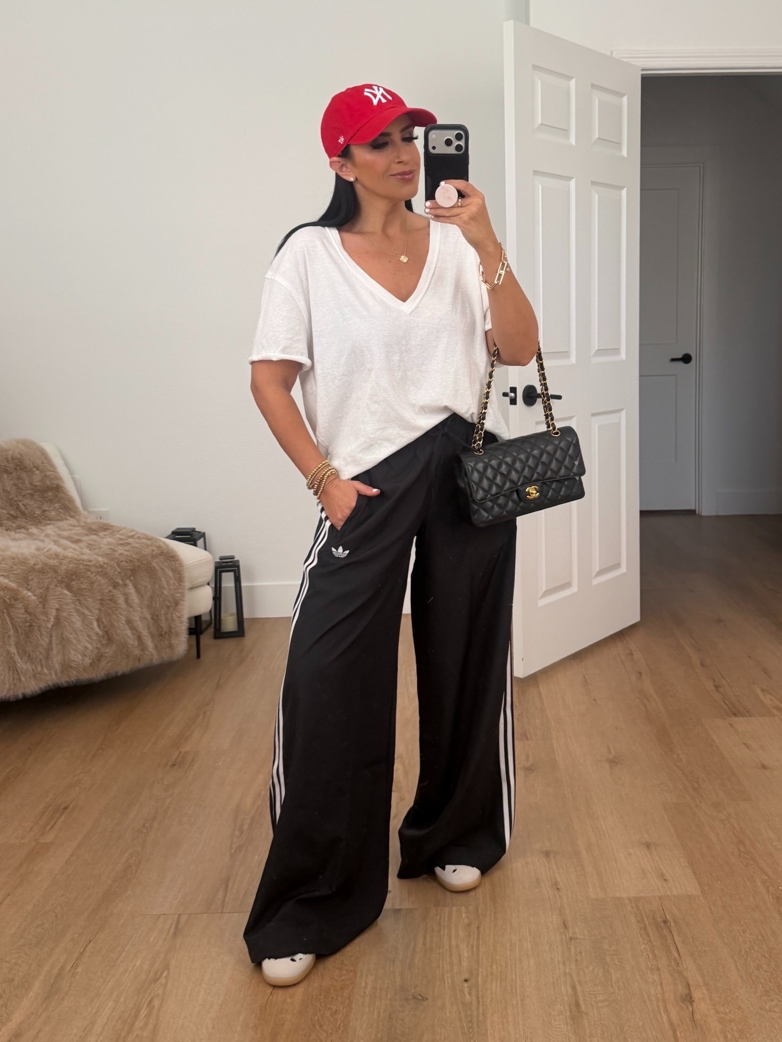 Adidas firebird adilenium track pants in black wearing size small. Free people oversized tee wearing size xs. Cow print sambas run true to size 