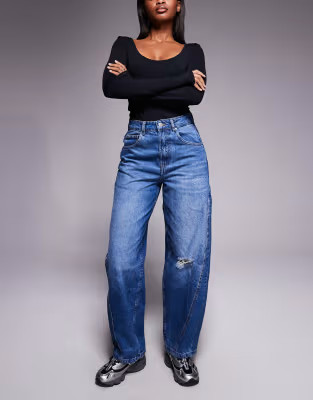 ASOS DESIGN barrel leg jeans with paneling and cinching in midwash with rips | ASOS (Global)