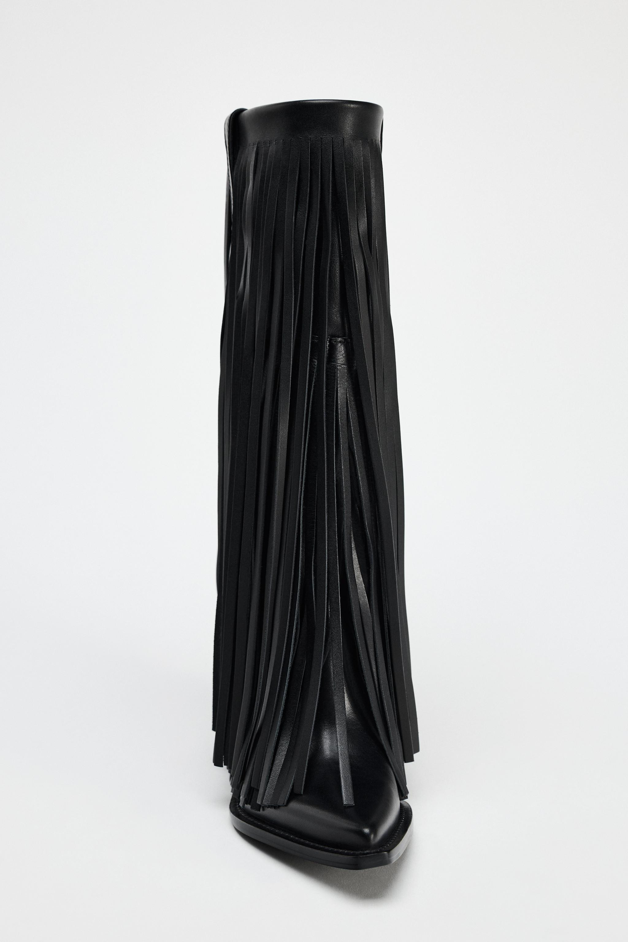 Knee high boots made of leather. Cowboy style. Fringe detail on the exterior. Side pull tabs. Poi... | Zara US