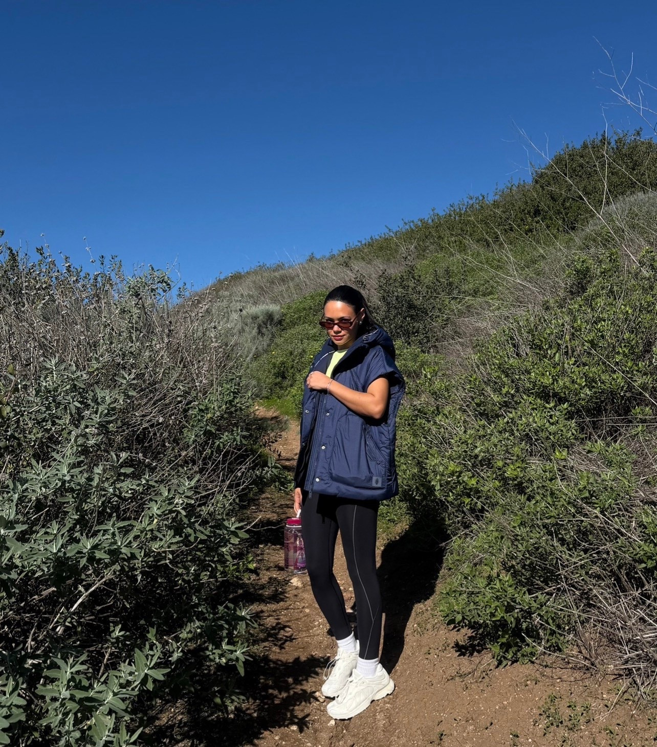 Free people movement hiking ootd | navy puffer vest, black leggings, Salomon white sneakers 

#LTKootd #LTKfitnessgoals #LTKdayinmylife