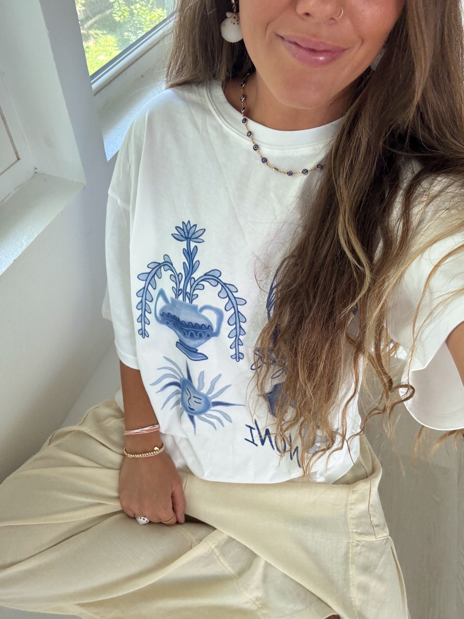 Shirt is from @nonithelabel use code heather10 🌟

She’ll earrings are Coastline Color, and blue necklace is Mahloe Designs. 