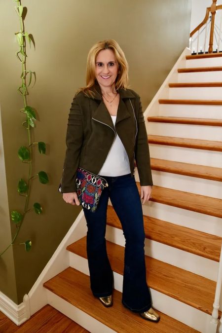 It’s amazing how this white knit top can liven up my moto jacket that’s been in my closet for years. 🤍💚  Add a colorful clutch and gold booties are you are good to go! Head to my latest blog post for the scoop on this look. Happy Tuesday! #motojacket #flaredjeans #winterstyle #fashionover50

#LTKfindsunder100 #LTKstyletip