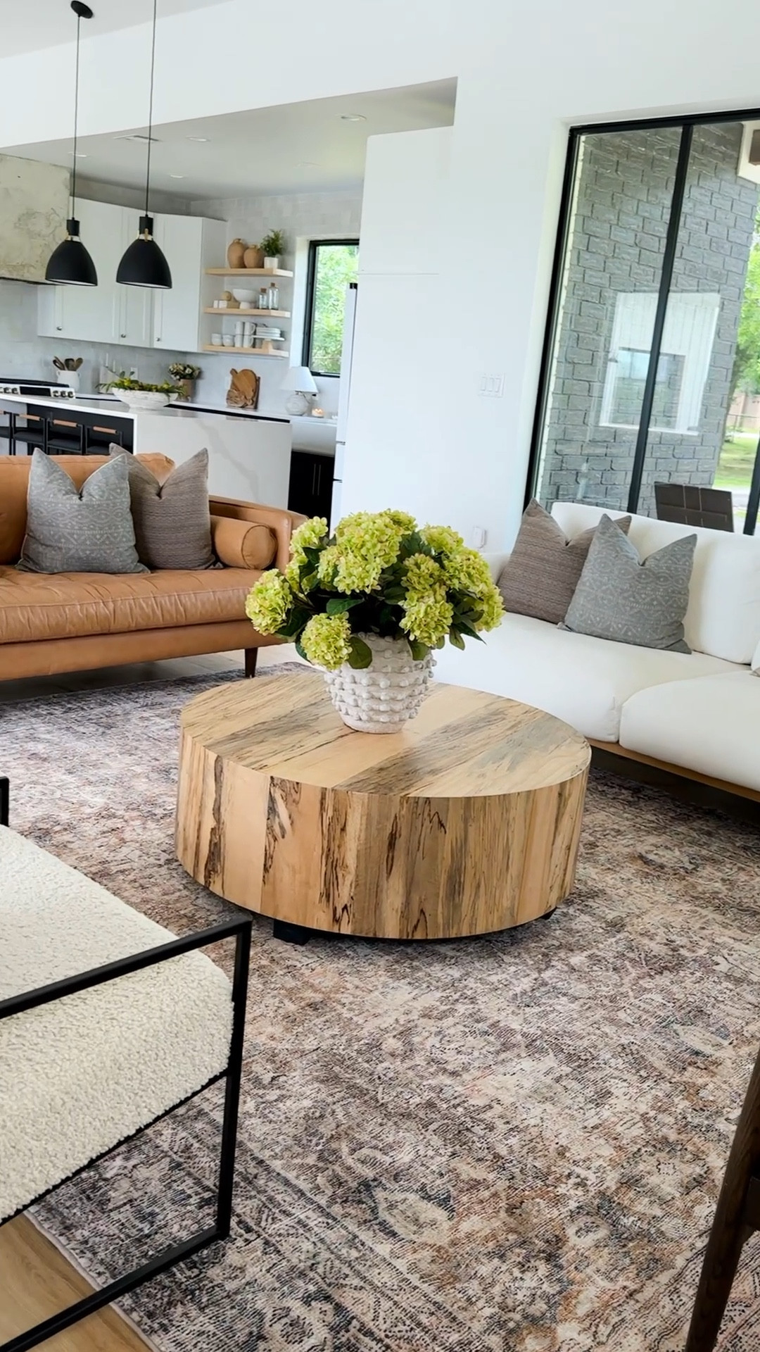 Our open-concept living, dining, and kitchen area is truly the heart of our home, designed with pieces that reflect our style and functionality for our family. The leather sofa anchors the living space, offering both durability and warmth, while the soft, textured throw pillows bring in a cozy, layered look. The oversized wood coffee table adds an organic touch and is perfect for gathering around. In the dining area, the black dining table and chairs create a bold, timeless contrast against the light-filled space, paired with a statement chandelier that ties everything together. 

The kitchen island serves as a centerpiece for the room, where conversations flow as easily as meals are prepared. I love how the decor pieces—like the lush greenery, subtle vases, and thoughtfully chosen accents—add personality and softness throughout the space. Every corner was designed with purpose, blending style and practicality for a home that feels both welcoming and uniquely ours.


#LTKHome #LTKSeasonal #LTKSaleAlert