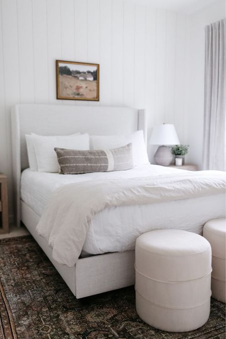 Two ottoman stools styled at the end of a queen upholstered bed. Guest bedroom, neutral bedroom  

#LTKsalealert #LTKstyletip #LTKhome