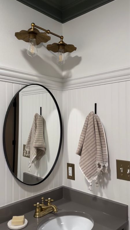 Guest bathroom reveal! The brass scalloped light is my favorite piece from this space! 

Brass scalloped vanity light, hearth and hand matte black towel hook, black oval vanity mirror, Amazon find, Amazon home, target home, brass light covers, brass faucet, marble soap dish 

#LTKstyletip #LTKhome