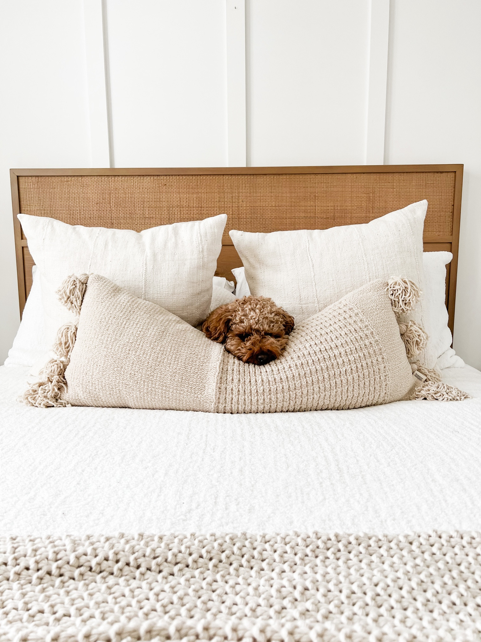 A bright white bedroom with a natural wood cane headboard - I love this vibe! Bedroom inspo. 

#LTKhome #LTKFind