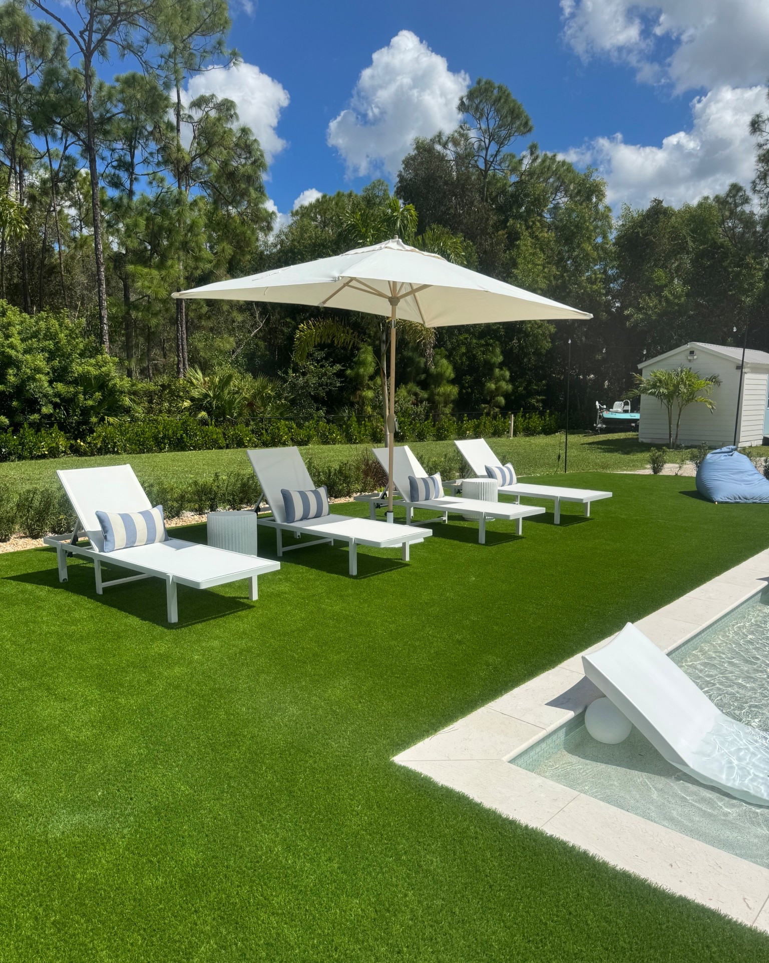 Soaking up the sun! White loungers and cabana striped blue pillows. Grab your favorite drink for the side table and watch the kids play in the pool. 

#LTKOver40 #LTKFindsUnder50 #LTKHome