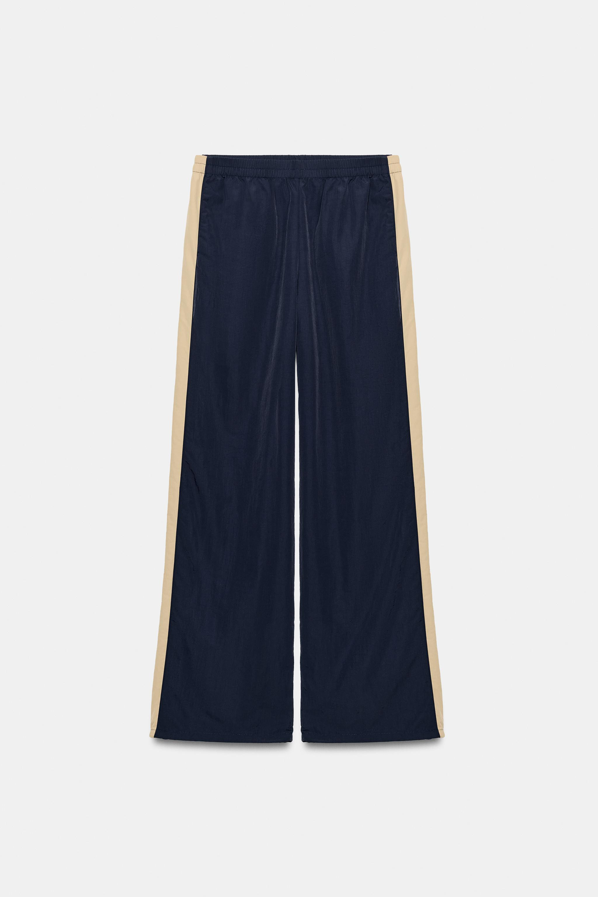 Mid-rise trousers with an elastic waistband. Side pockets concealed in the seams. Contrasting sid... | Zara US