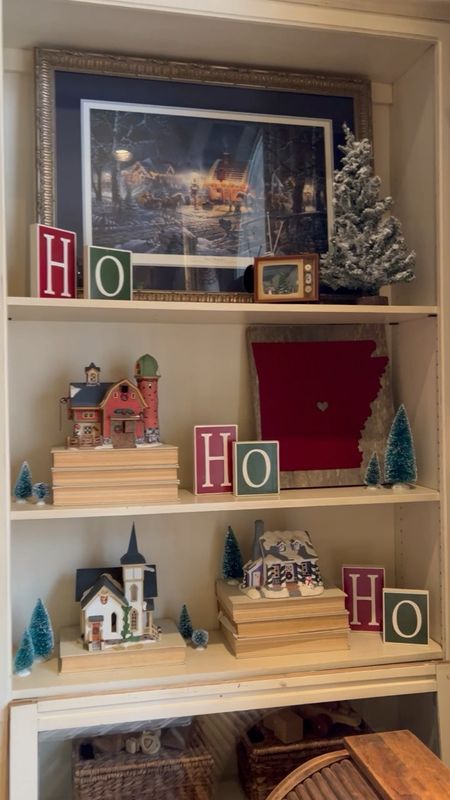 Christmas village pieces and other Christmas accessories always go on my bookshelf including this special art.

#LTKhome #LTKSeasonal #LTKHoliday