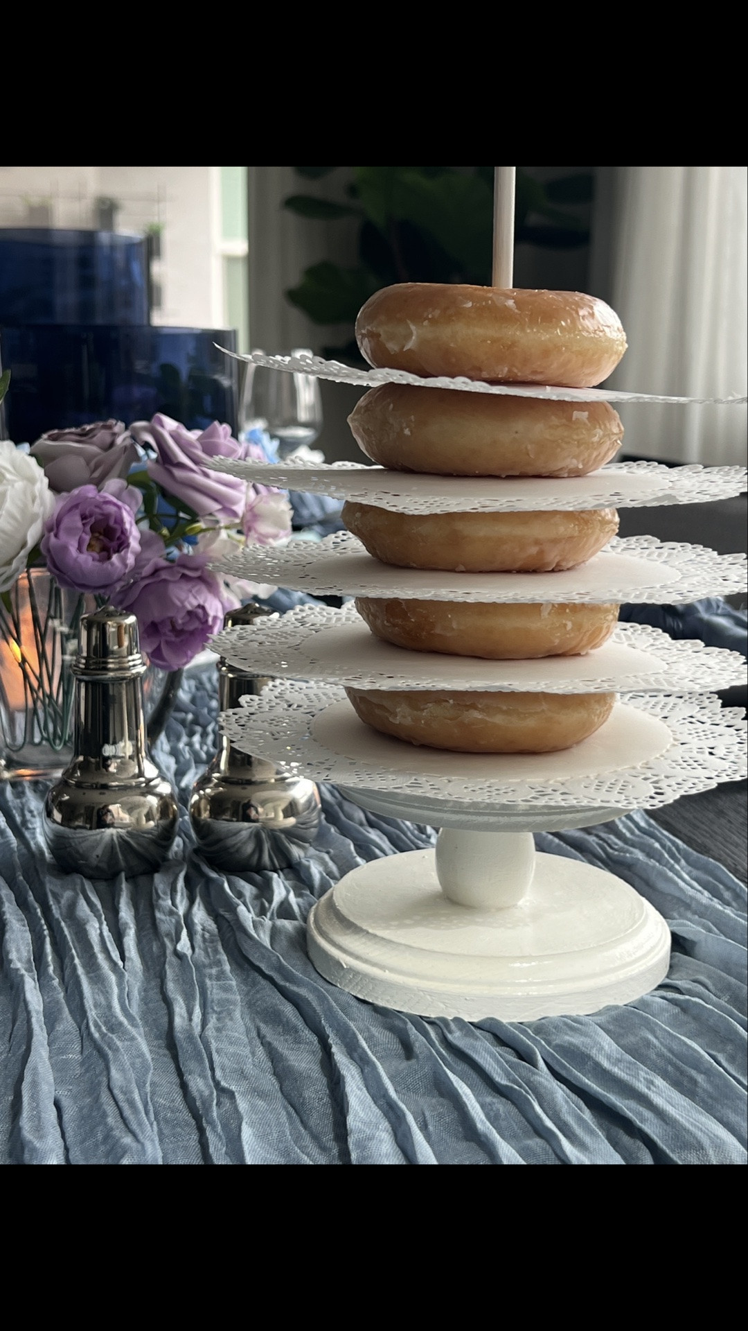 Blue and white and lavender tablescape with blue glass cylinder, blue, and white and lavender faux florals, dusty blue gauze Runner, silver serving pieces, donut stand, brunch table, Spring tablescape, summer tablescape, blue and white tablescape

#LTKSeasonal #LTKHome