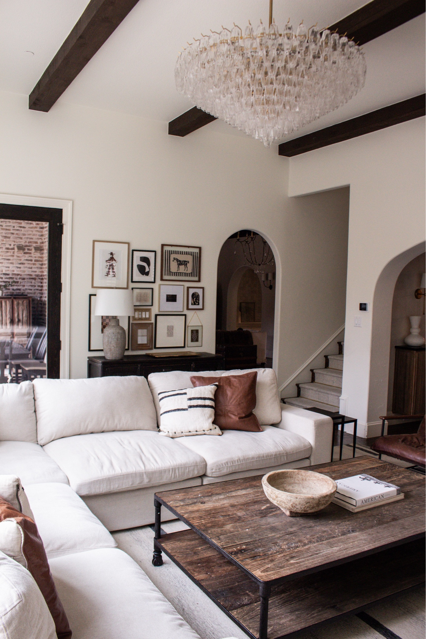 Simple, clean, and timeless. Large sectional couch, rustic wood coffee table, modern chandelier lighting, open floor plan ideas.

#LTKSeasonal #LTKHome