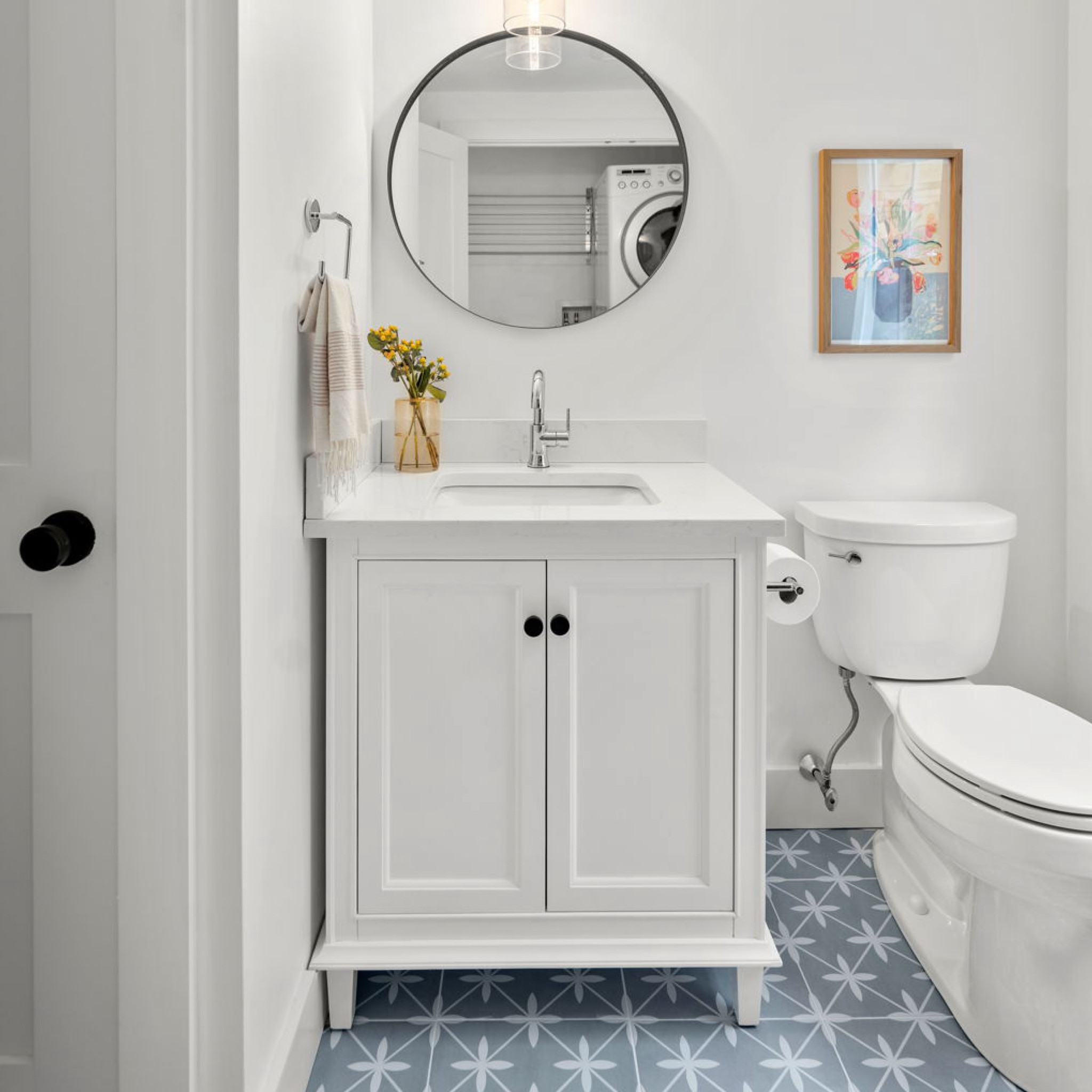 powder bathrooms often present an opportunity to have fun and make bold design choices, but we opted for a more traditional look with this #dwelloctoberstudio project since this bathroom was located off the main floor landing. although we kept things simple with a white vanity, gray quartzite countertop, and chrome fixtures, the blue patterned floor tile adds the perfect amount of color and personality to the space. #dwelloctober

#LTKhome
